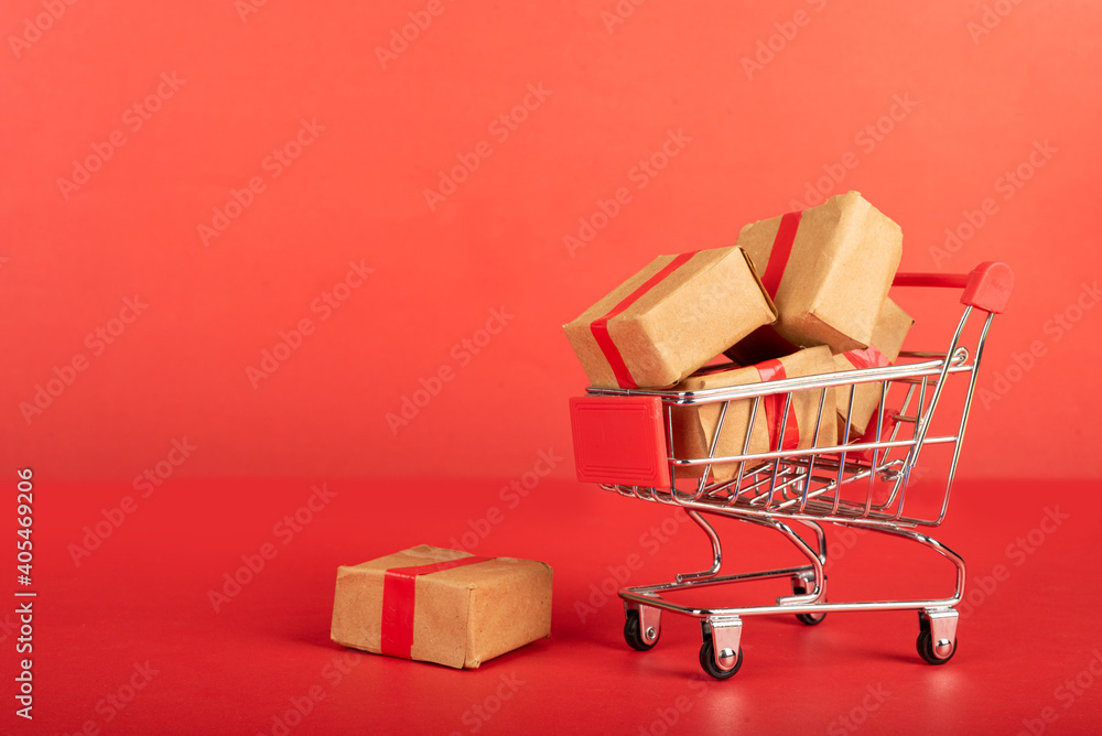 : A Miniature shopping cart fill with three boxes.