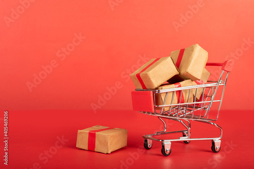 : A Miniature shopping cart fill with three boxes.