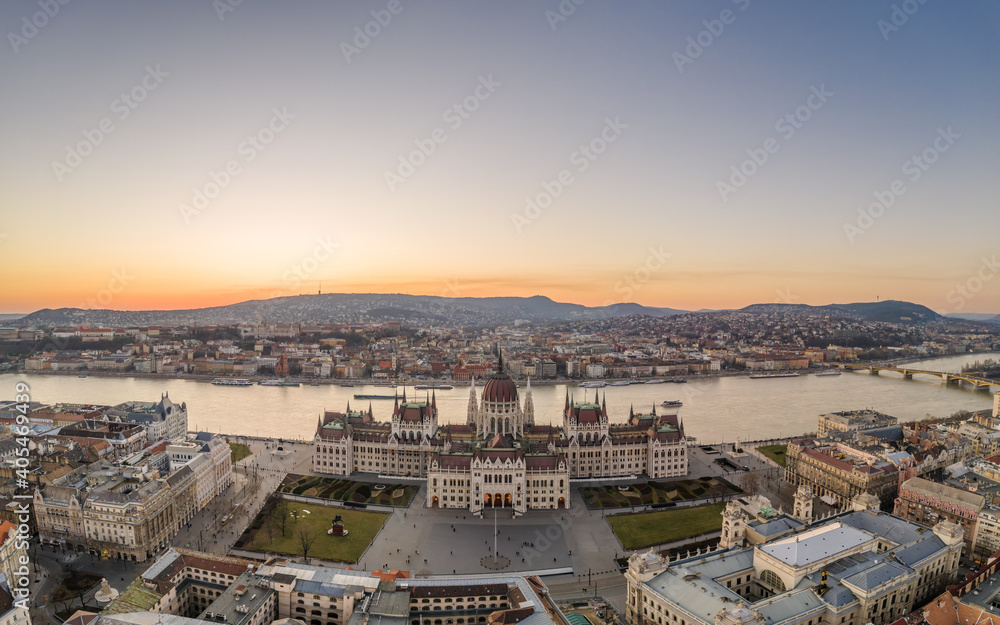 Aerial drone shot of Hungarian Parliament by Danube river in Kossuth Square in Budapest sunset