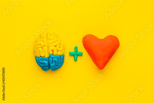 Emotional intelligence concept. Brain and heart made of clay, top view