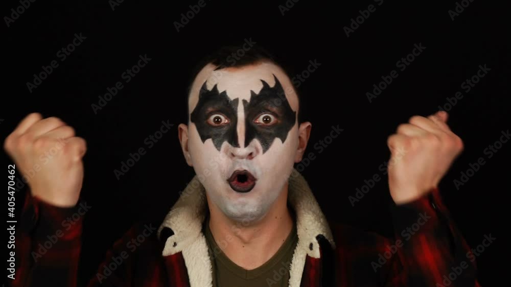 Amazed Winning Emotions of Funny Impressed Screaming Man in Demon Makeup on Black Background Amazed Winning Emotions of Funny Impressed Screaming Man in Demon Makeup on Black Background