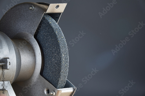 Abrasive emery for sharpening tools close up on gray background. photo
