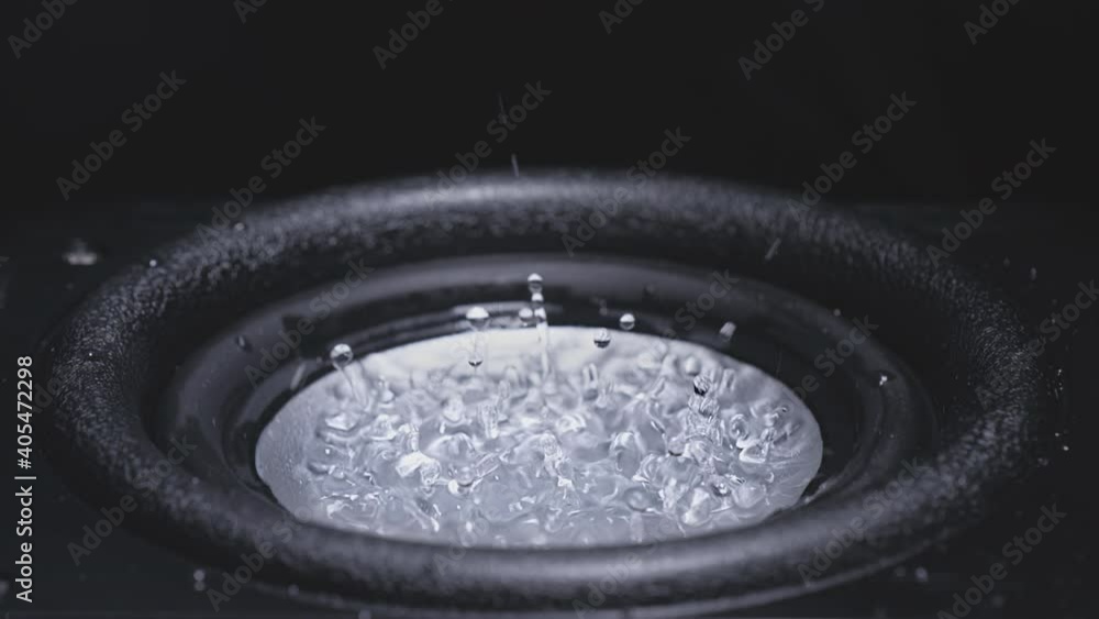 Dark Wave Audio and Black Water Liquid on a Plate. Subwoofer speaker with water. Droplets explode over the sound of the bass. Liquid jumps on the audio speaker. Background for a party. Slow motion. Dark Wave Audio and Black Water Liquid on a Plate. Subwoofer speaker with water. Droplets explode over the sound of the bass. Liquid jumps on the audio speaker. Background for a party. Slow motion.