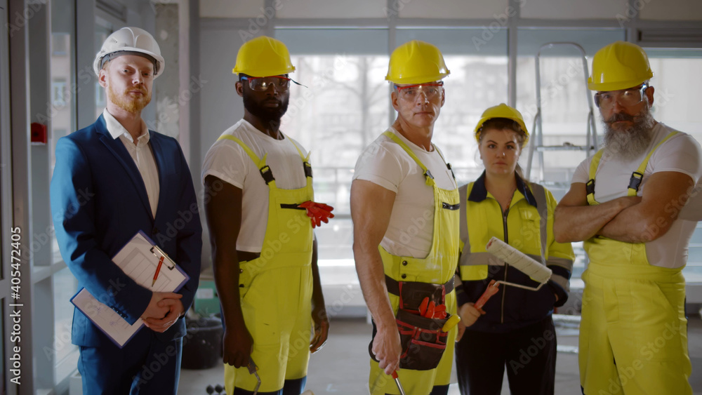 Portrait of diverse team of professional builders at construction site Portrait of diverse team of professional builders at construction site