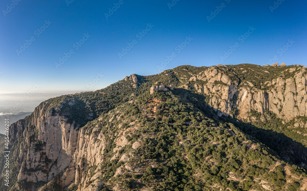 Panoramic aerial drone view of Holy Cave of Montserrat on mountain near Barcelona in sunrise