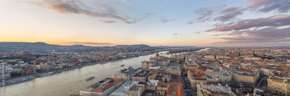 Parnoramic Aerial drone shot of Hungarian Parliament Kossuth Square by Danube river in Budapest sunset