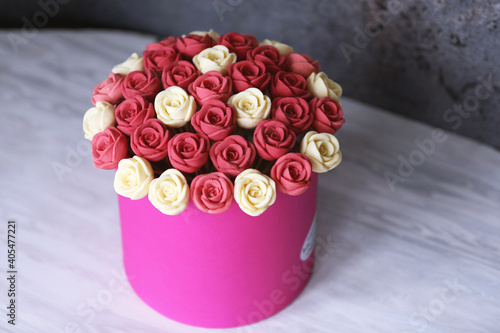 Fototapeta Naklejka Na Ścianę i Meble -  Homemade chocolate roses bouquet, white, pink and red sweet flowers in festive pink vase, grey abstract background, front view. Valentines Day concept