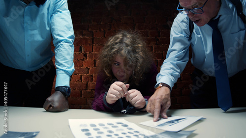 Canvas Print Aggressive police officers yelling at scared woman suspect during interrogation