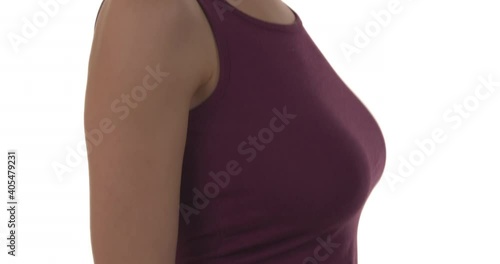 Close-up of young woman bouncing her large breasts. Isolated on white background. Slow motion.