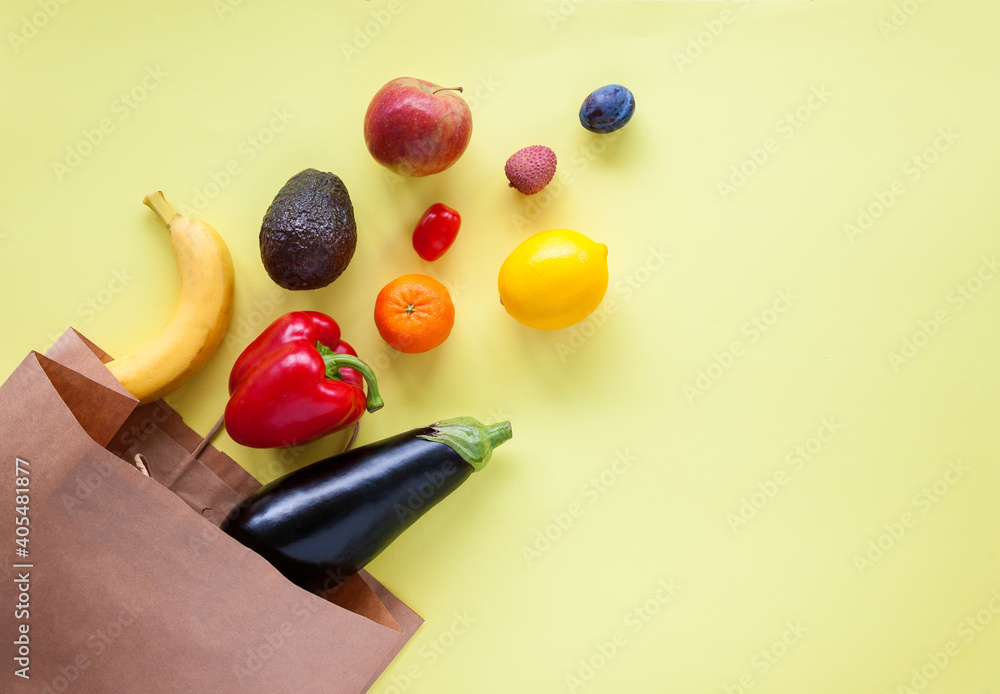 Paper bag with different products on a yellow background Paper bag with different products on a yellow background