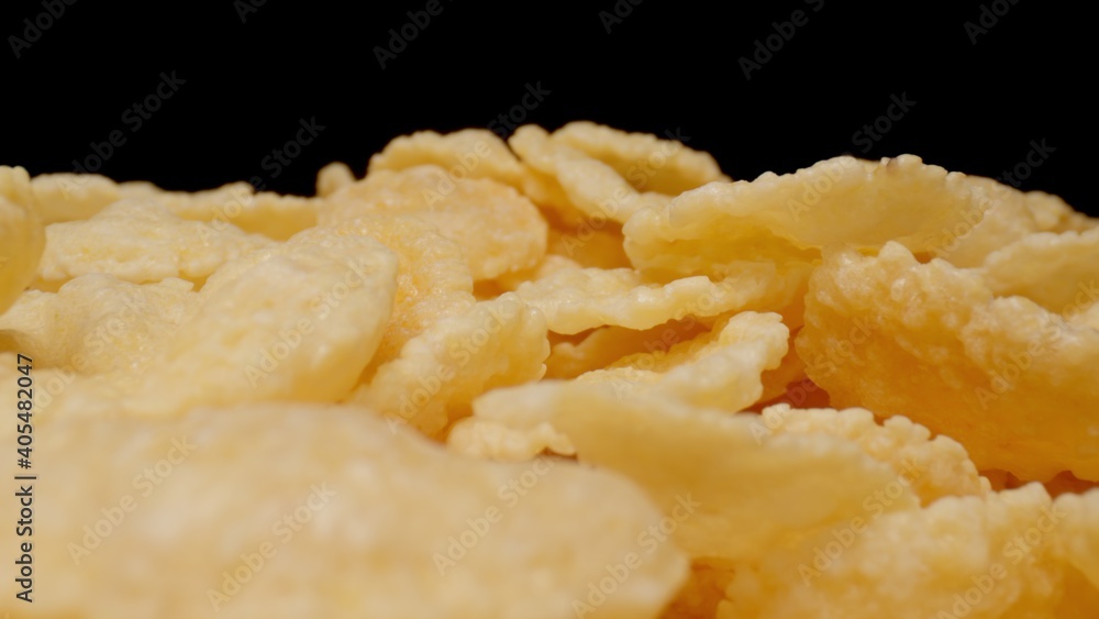 MACRO: Sweet corn flakes on a black background MACRO: Sweet corn flakes on a black background