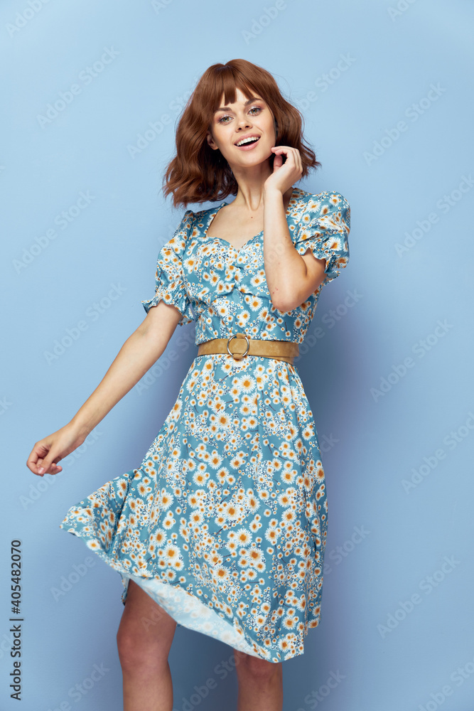 Woman in dress hand near face smile attractive look short hair Woman in dress hand near face smile attractive look short hair