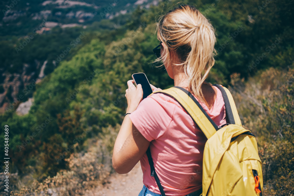 Woman using smartphone while travelling alone