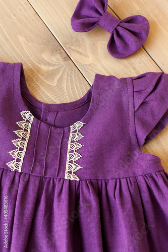 Purple sleeveless dress made of linen fabric. Baby Dress