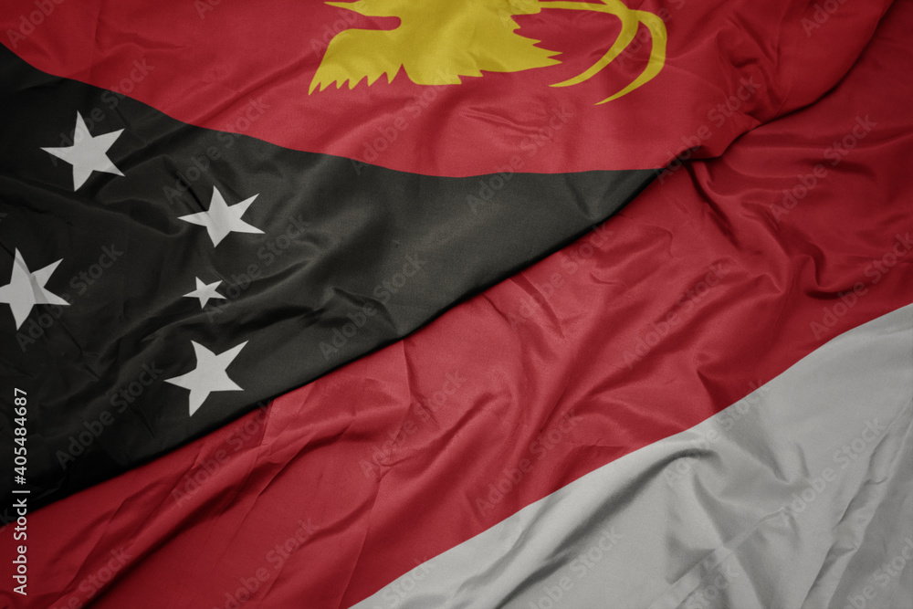 waving colorful flag of indonesia and national flag of Papua New Guinea . waving colorful flag of indonesia and national flag of Papua New Guinea .