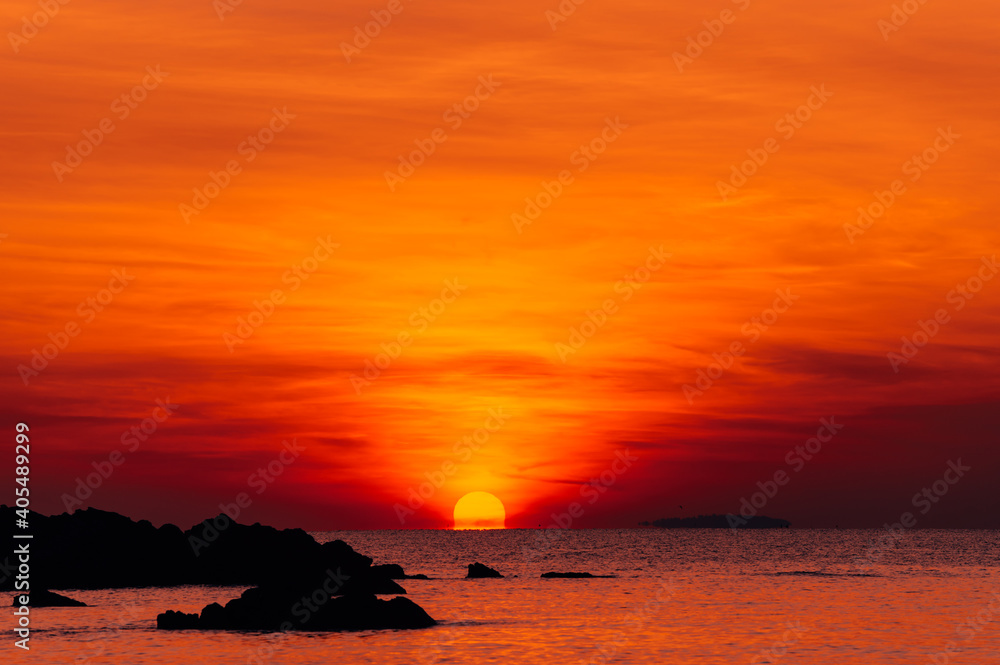 Red sunset sunrise over ocean sea. Beautiful Sunrise. Glowing sea sunrise.