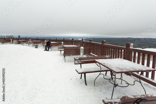 Benches and tables on the viewpoint in the mountains in winter.