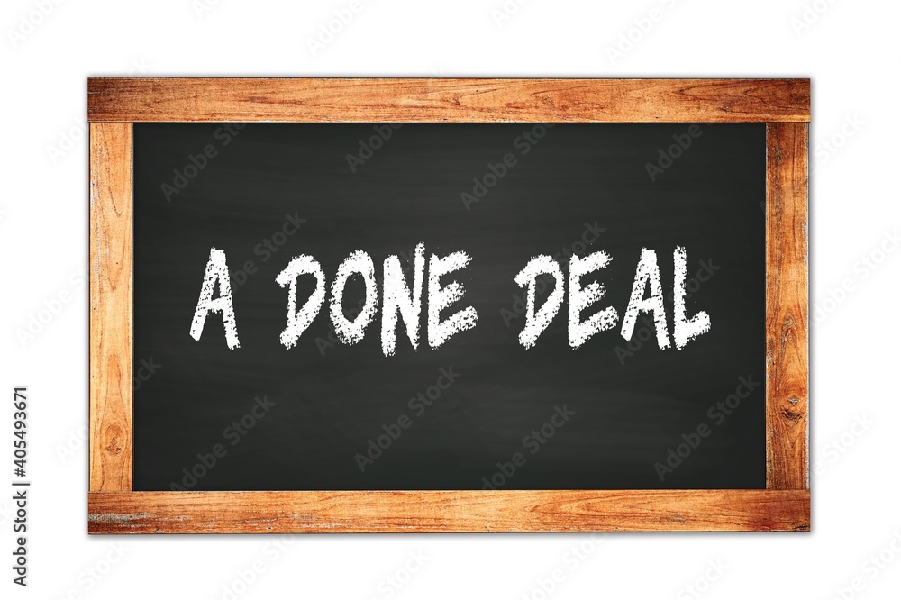 Obraz premium A DONE DEAL text written on wooden frame school blackboard.