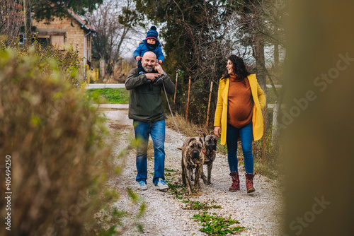 Family is taking a dogs for a walk and enjoying outdoor activities © Clarity Photo