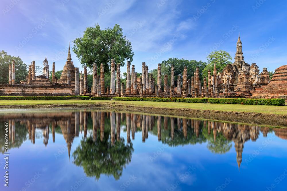 Pagoda and ruined monastery complex at Wat Mahathat temple with reflection, Sukhothai Historical Park, Thailand