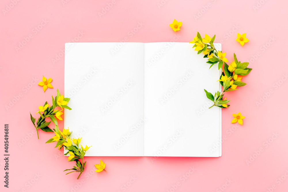 White paper mock up with yellow flowers, view from above White paper mock up with yellow flowers, view from above