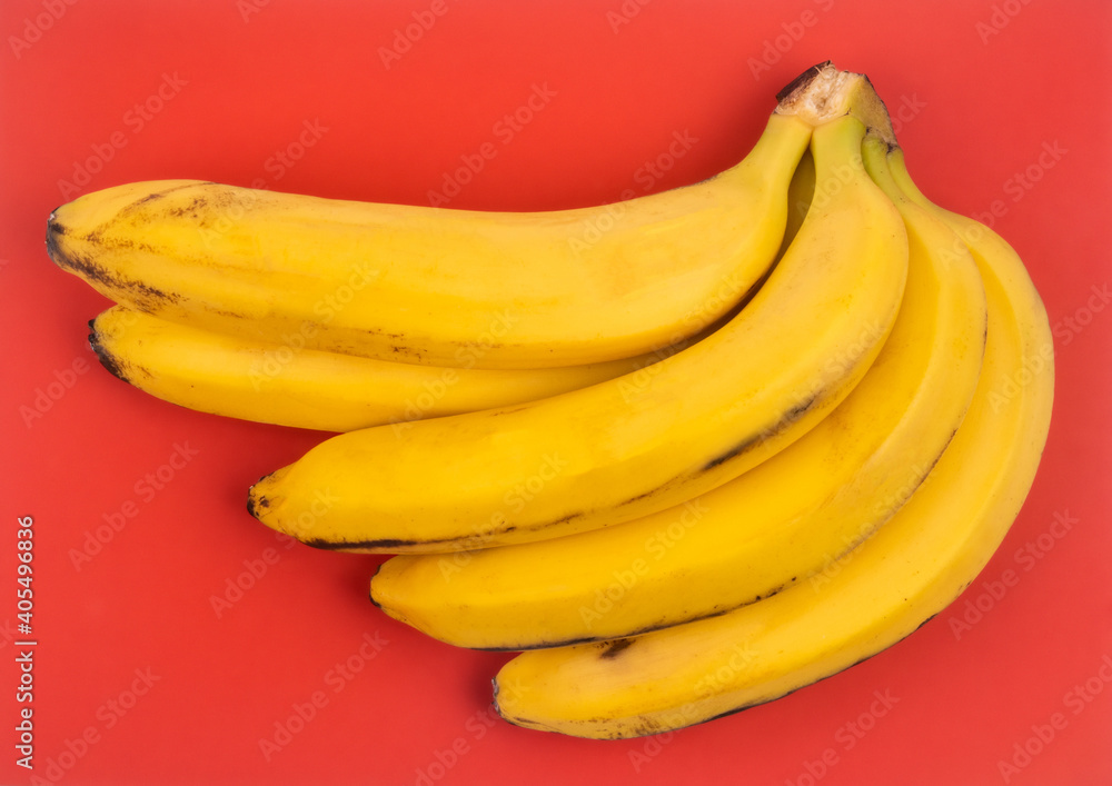 bunch of bananas on red background