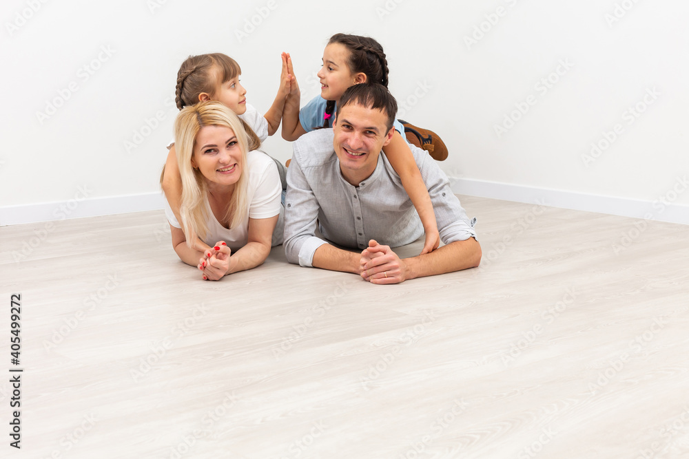 Smiling young parents and their children are very happy, they are at home Smiling young parents and their children are very happy, they are at home