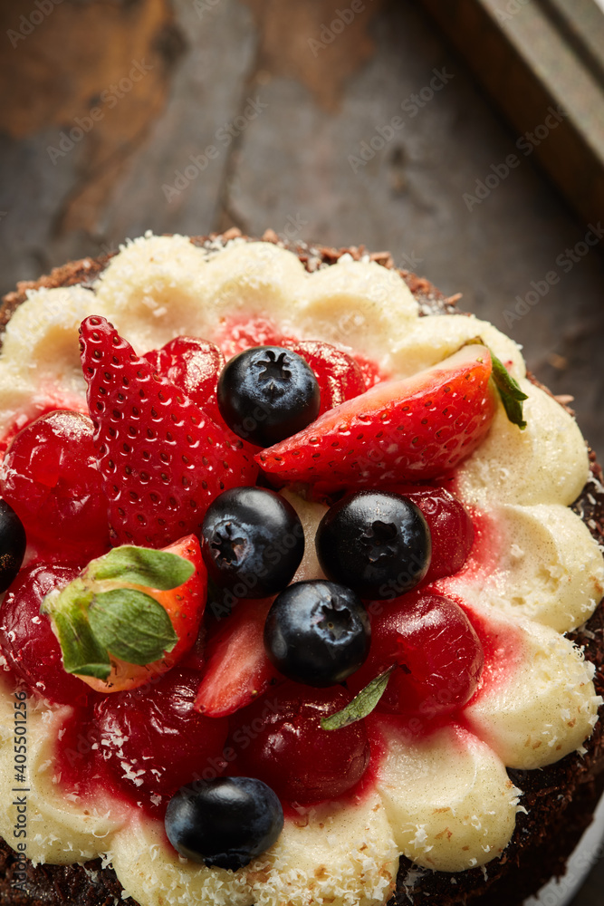 Black forest cake, Schwarzwald pie, dark chocolate and cherry dessert on a white wooden background.