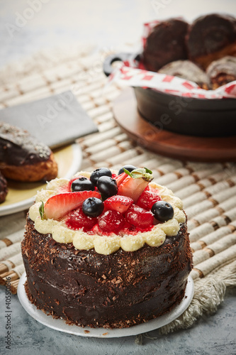 Black forest cake, Schwarzwald pie, dark chocolate and cherry dessert on a white wooden background.