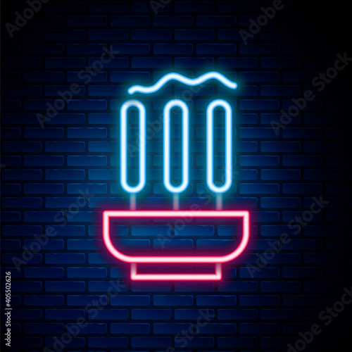 Glowing neon line Burning aromatic incense sticks icon isolated on brick wall background. Colorful outline concept. Vector.