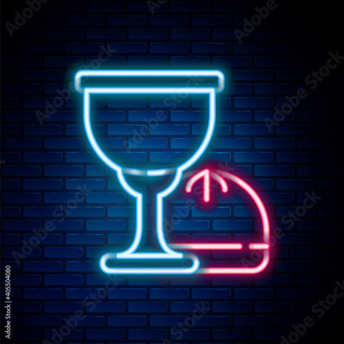 Glowing neon line Holy grail or chalice icon isolated on brick wall background. Christian chalice. Christianity icon. Colorful outline concept. Vector.