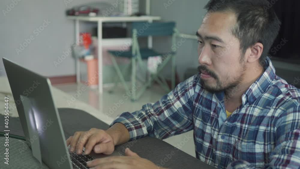 a man working from home use laptop in the bed room a man working from home use laptop in the bed room