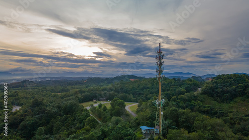 Aerial view of 5G Communication tower during beautiful sunrise with clouds