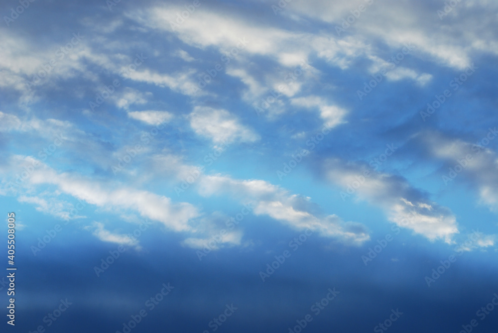 Blue tone of evening cloud and sky before sunset. Peaceful sky in calm atmosphere. A fluctuation weather make a dreamy and imaginative cloudscape. Wide blue sky background.
