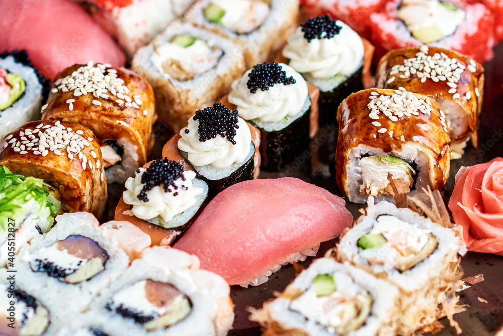 Set of delicious various rolls and sushi in a glass plate Set of delicious various rolls and sushi in a glass plate