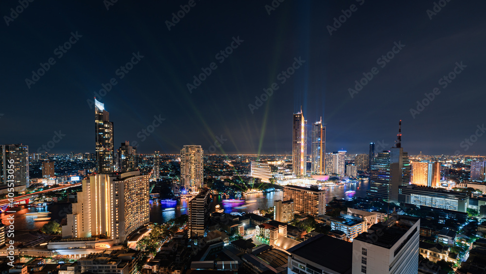 Laser light show with skyscraper and colorful cruise in Chao Phraya riverside at Bangkok
