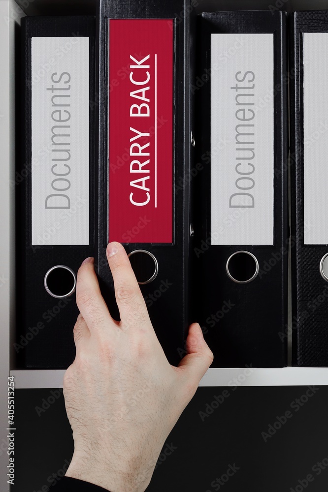 Carry Back. Folder with label on the shelf of a lawyer. Red label with text in focus. Carry Back. Folder with label on the shelf of a lawyer. Red label with text in focus.