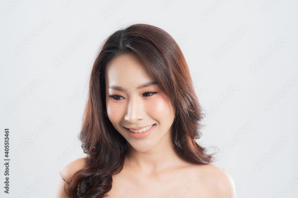 Beautiful young woman with clean fresh skin, Hair sleek, Proposing a product. Gestures for advertisement on gray background, Front view, with copy space. Beautiful young woman with clean fresh skin, Hair sleek, Proposing a product. Gestures for advertisement on gray background, Front view, with copy space.
