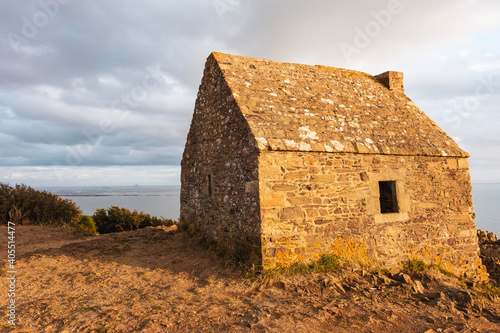 One lonely house on the edge of the cliff, with sea horizon on the distance