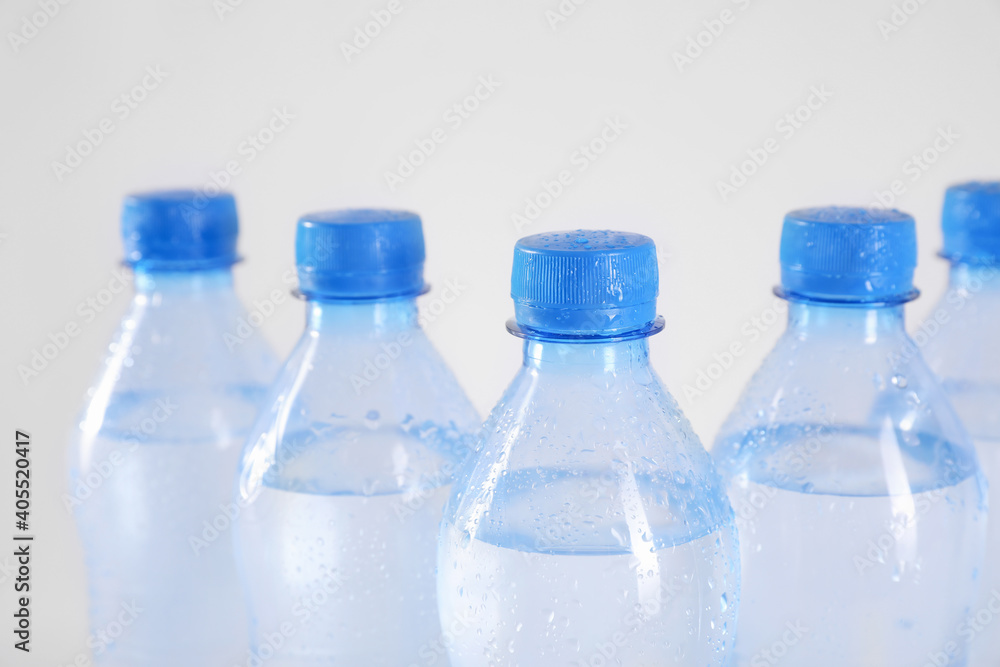 Plastic bottles with pure water on white background, closeup Plastic bottles with pure water on white background, closeup