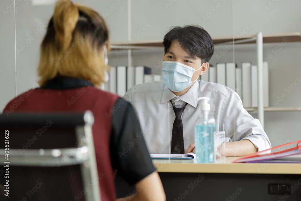 Safe communication at work and social distance during covid-19 quarantine. Colleagues talk through protective glass, Safe communication at work and social distance during covid-19 quarantine. Colleagues talk through protective glass,