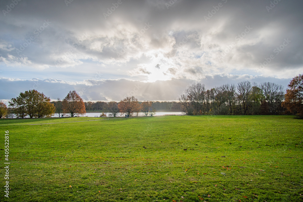 beautiful sun and sky and autumn landscape at werdersee, a river in bremen