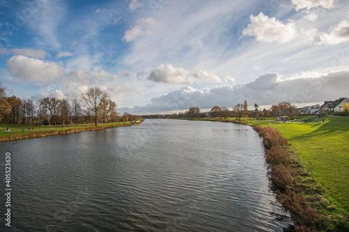 view from bride to dike and beautiful werdersee, a river in bremen, in the sun with amazing sky