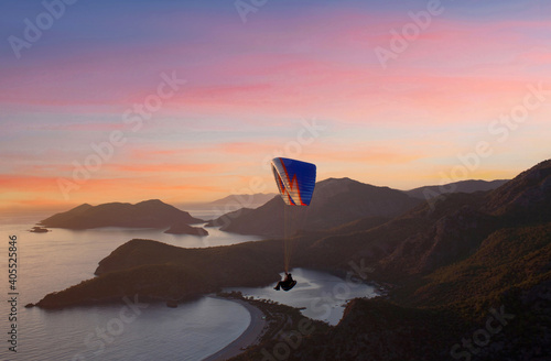 Paraglider flying at sunset over Blue lagoon in Oludeniz, Turkey