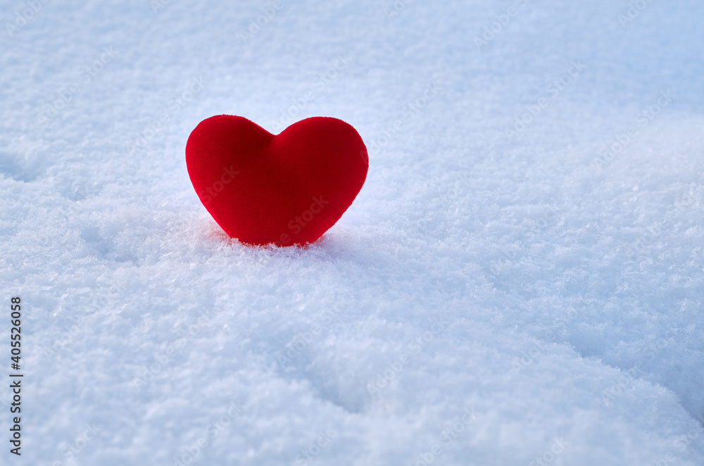 A red hot heart lies on the cold snow.