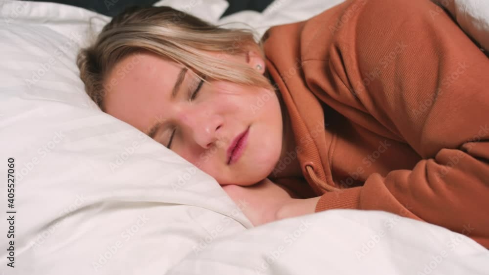 Close up portrait of relaxed woman sleeping on a white pillow in bed. Portrait of young Caucasian woman resting in bedroom at home. Leisure and relaxation. Close up portrait of relaxed woman sleeping on a white pillow in bed. Portrait of young Caucasian woman resting in bedroom at home. Leisure and relaxation.