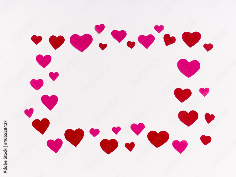 Top view on blank postcard or invitation paper on white background with pink and red hearts shape papercut for Mother's Day and valentine season concept Top view on blank postcard or invitation paper on white background with pink and red hearts shape papercut for Mother's Day and valentine season concept