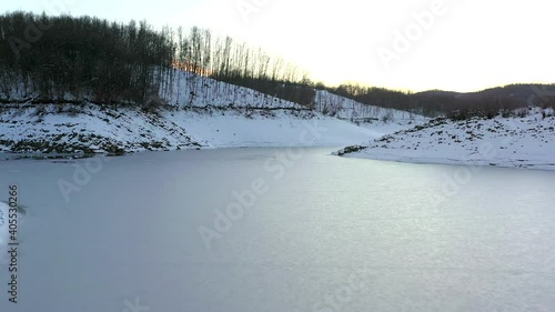 Aerial view of frozen mountain lake.
Scandarello lake in Amatrice, Rieti, Italy, under a blanket of snow photo