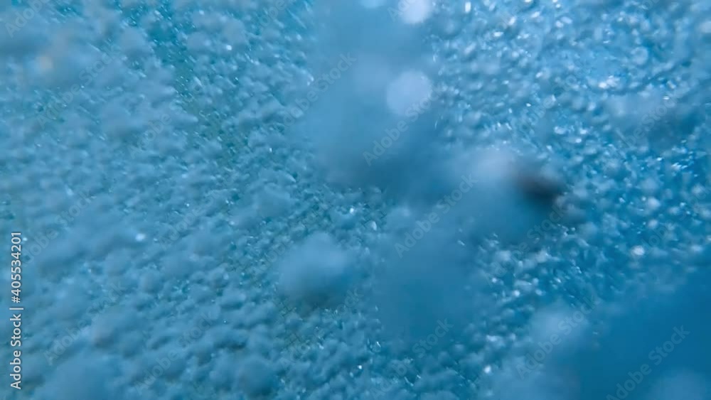 Closeup slow motion of lots of air bubbles floating up to the water surface in swimming pool. Beautiful underwater background or backdrop. Closeup slow motion of lots of air bubbles floating up to the water surface in swimming pool. Beautiful underwater background or backdrop.