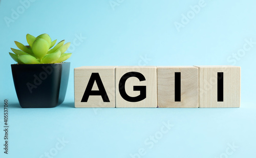 AGII. text on wood blocks on blue background. concept of medicine photo